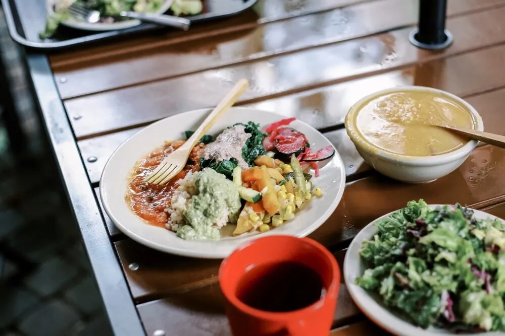 a-healthy-whole-foods-plant-based-meal-with-eco-friendly-wooden-utensils-sits-on-an-outdoor-table_t20_pLmOaP.jpg