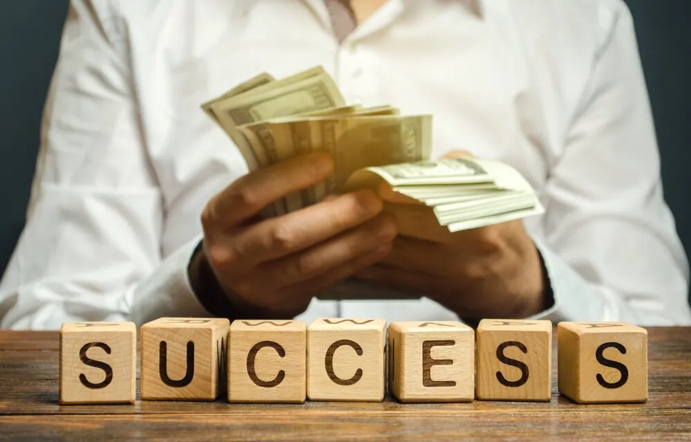 business-success-profit-wealth-successful-achievement-development-achieving-blocks-budget-businessman_t20_GJ279R.jpg