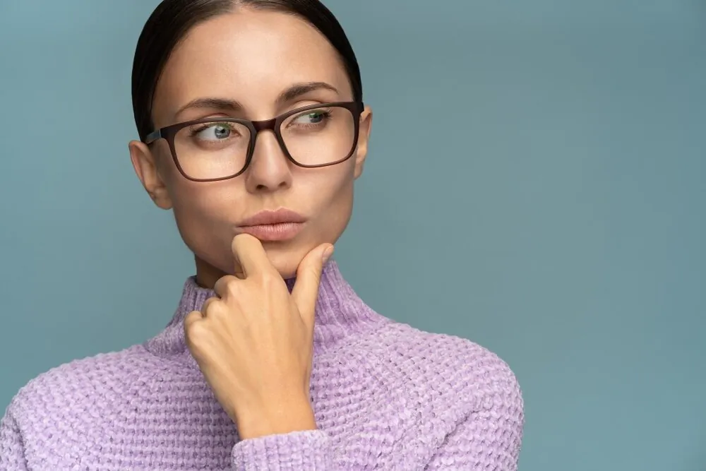 self-assured-serious-business-woman-in-sweater-wear-glasses-puts-her-chin-looking-at-free-space_t20_N0zN07.jpg