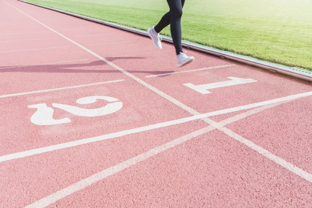 female-athletes-are-running-into-the-finish-line-at-number-1-in-the-running-track-of-the-stadium_t20_LOrLpz.jpg